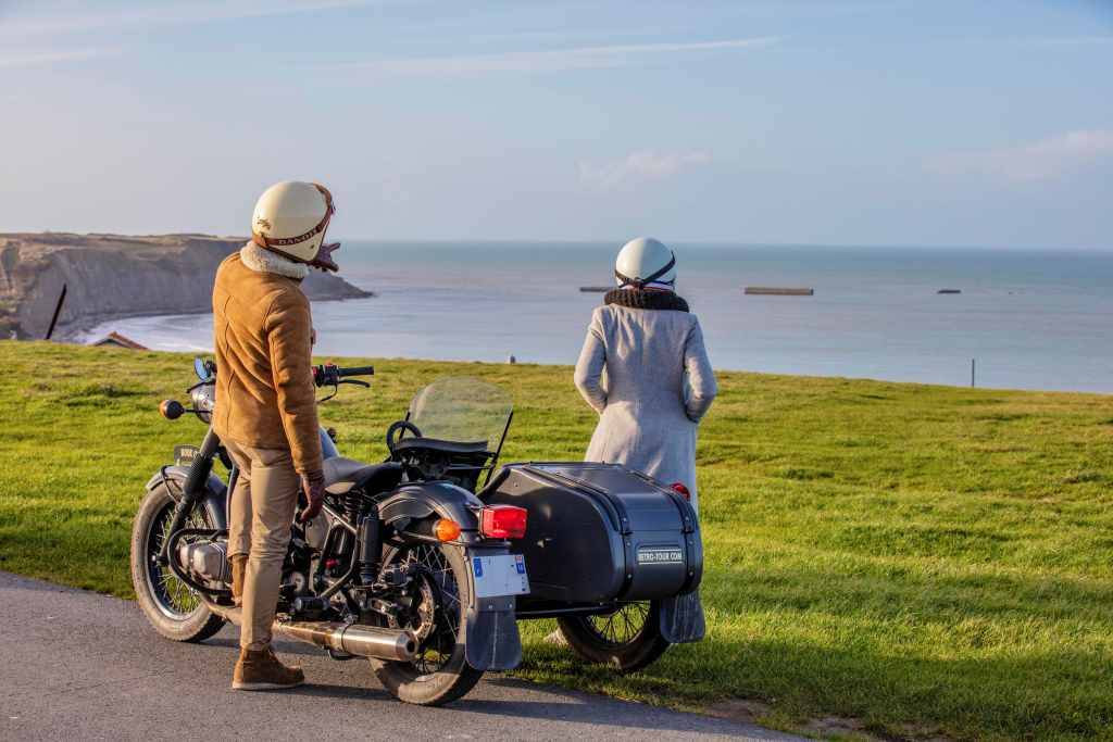 Sidecar driver and tourist on Etretat Cliffs during a stop along the way of a Tour in Normandy, a unique experience