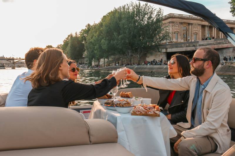 People eating at a pontoon boat during Paris Seine River Private Cruise by Deluxe France