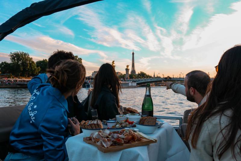People having dinner at the end of the day at a pontoon boat by Deluxe France
