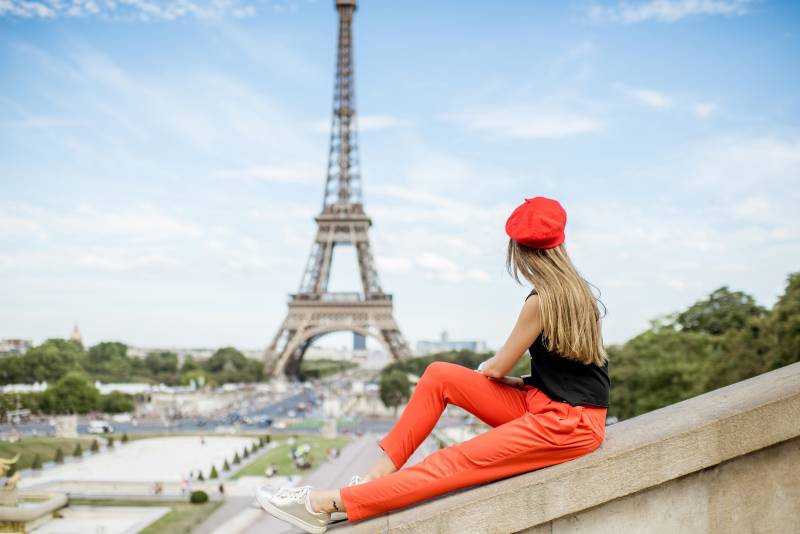 Woman with red beret very french woman staring at the Eiffel Tower from trocadéro