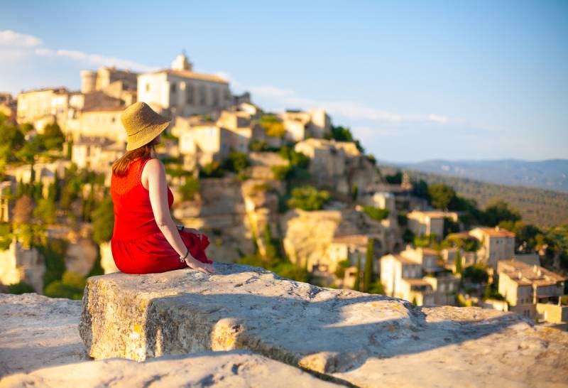 Woman staring at Gordes Village on the horizon during a Luberon Villages & Wine Tastings Full Day Private Tour