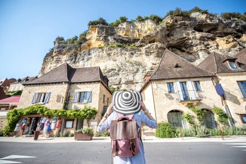 Tourist admiring a Dordogne village during a Full Day Dordogne & Lascaux Cave sightseeing tour with Deluxe France