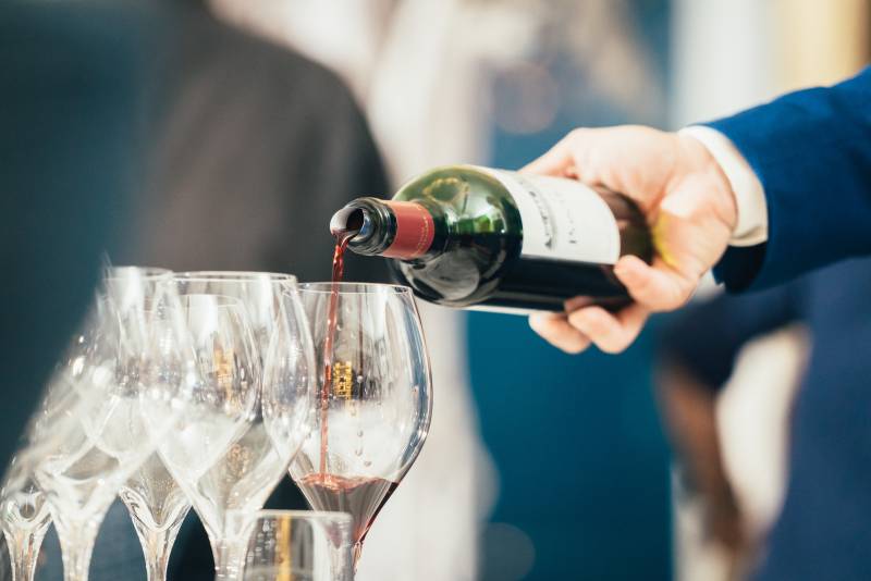 red wine bottle being served in glasses