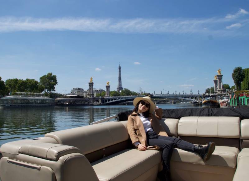 Woman chilling under the sun at a Pontoon Boat cruise in the Seine by Deluxe France