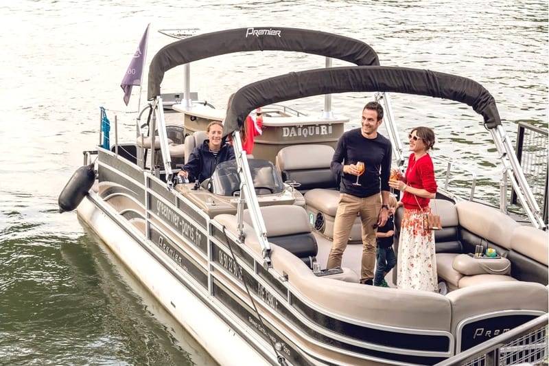 a couple on a pontoon boat during a Paris Seine River Private Cruise